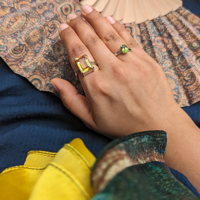 Statement citrine and peridot rings styled with silk scarf