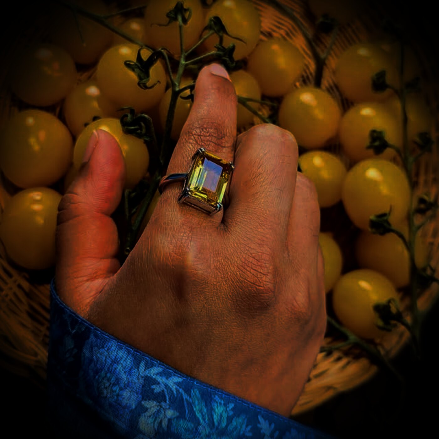 An emerald-cut citrine ring catching warm gold light.