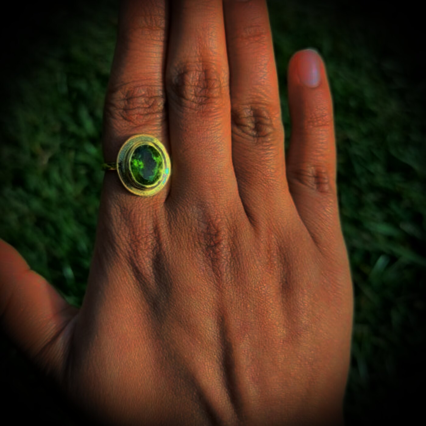 A peridot ring against a dark green Peak District ground.